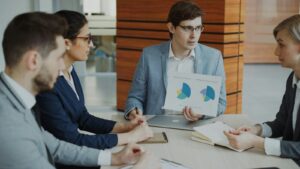 Team discussing charts during a business meeting